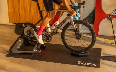 A cyclist trains indoors on a Tacx bike trainer, a device that allows you to ride your bicycle stationary.