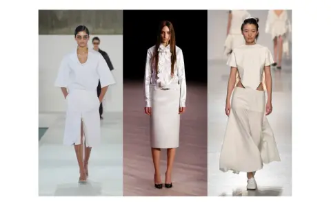 Sfilata di moda con tre modelle che indossano abiti eleganti in **dress code total white**. Gonne lunghe e top asimmetrici.