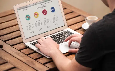 Mężczyzna pracuje na laptopie, przeglądając stronę internetową firmy CyberRabbit. Strona prezentuje usługi: rozwój stron, wsparcie techniczne, grafika i social media. To jest przykład, print co to jest.