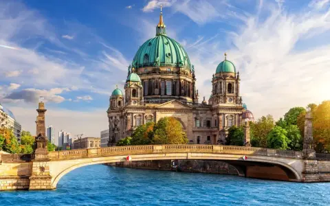A stunning view of Berlin Cathedral across the Spree River, perfect for your next travel to Berlin.