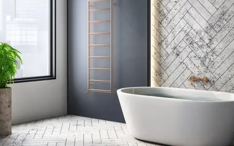 Radiador de agua vertical de cobre, un ejemplo de tipos de radiadores de agua, junto a una bañera y una planta.