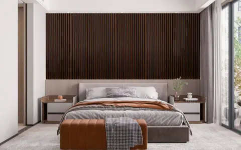Sovrum panel inspiration: mörka träpaneler bakom en säng med grå sängkläder och en brun pall.