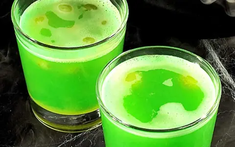 Två glas med bubblig, självlysande grön dryck, perfekt för ett spännande bål barnkalas.