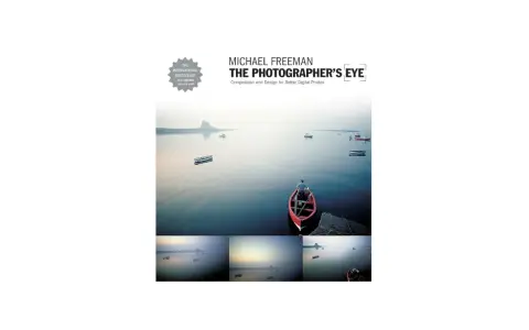 Book cover for "The Photographer's Eye" by Michael Freeman, featuring a serene seascape with boats and a lone figure in a red boat, showcasing the power of a photographer's eye.