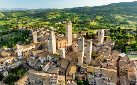 Aerial view of San Gimignano, Italy, with its medieval towers and Tuscan countryside.