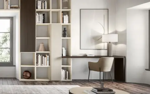 Angolo studio in soggiorno ricavato da libreria componibile. Scrivania integrata, sedia, lampada e quadro astratto.
