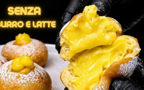 Bomboloni alla crema, soffici e ripieni, senza burro e latte. Un'esplosione di dolcezza.