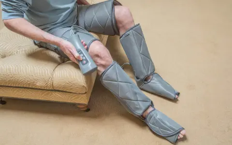 Man using a leg compression machine, enjoying the benefits of improved circulation and muscle recovery.