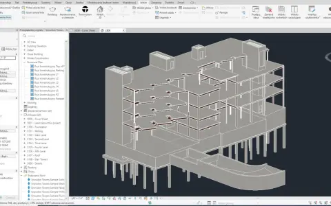 Widok 3D budynku w programie Revit. Widoczna konstrukcja pięter, słupy i fundamenty. W panelu po lewej stronie widać opcje widoku i przeglądarkę projektu.