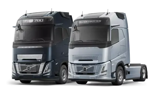 Dwa nowoczesne Volvo FH16 780 i FH Globetrotter, jedne z najlepszych ciężarówek na świecie, prezentują się na czarnym tle.