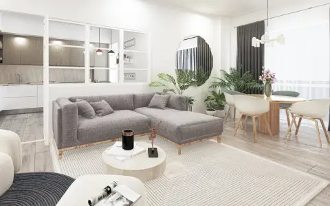 Soggiorno moderno con divano grigio, tavolino rotondo e cucina a vista. L'arredamento minimalista e i toni neutri evocano un caldo **stile nordico**.