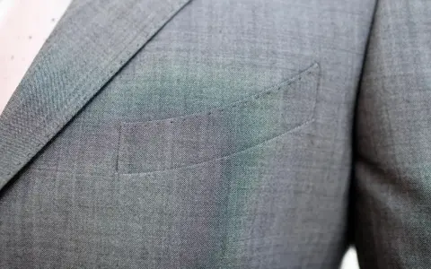 A suit jacket's breast pocket is sewn shut. This is often done to maintain the jacket's crisp silhouette, as why are pockets sewn shut is a common question for new suit owners.