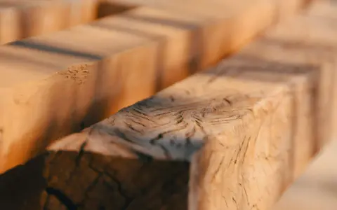Close-up of rough-hewn wooden beams, evoking the question: was Jesus a carpenter?