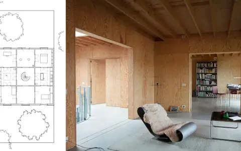 Plano de casa con paredes de madera y un sillón acogedor, ideal para un flex living.
