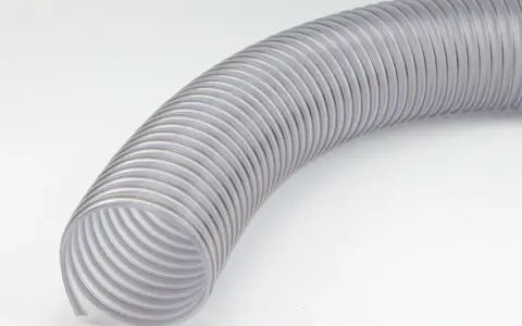 Przezroczysty wąż odciągowy z widocznym spiralnym wzmocnieniem, zagięty na białym tle.