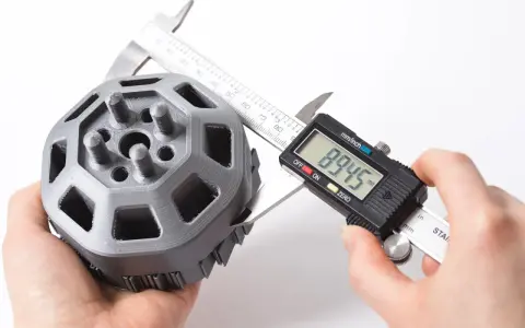A caliper measures a 3D printed part, showcasing the precision of 3D printing.