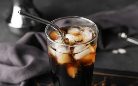 Erfrischender Cold Brew Kaffee in einem Glas mit Eiswürfeln und einem Metallstrohhalm. Perfekt für heiße Tage.