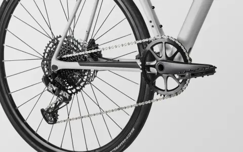 Close-up of a modern MTB drivetrain, featuring a SRAM rear derailleur, a wide-range cassette, and a single-chainring crankset.