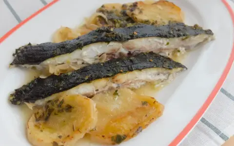 Rodaballo al horno con patatas y cebolla, un plato jugoso y lleno de sabor.