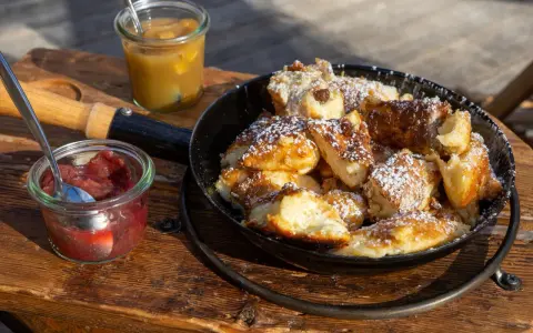 Kaiserschmarrn mit Puderzucker und Apfelmus. Die Kaiserschmarrn Kalorien sind es wert für diesen Genuss!