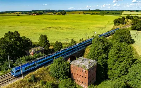 Pociąg mknie przez zielone pola, mijając stare forty. Idealny sposób, by dowiedzieć się, gdzie na Mazury pociągiem.