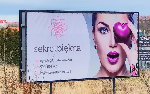 Reklama salonu "Sekret Piękna" z wizerunkiem kobiety i sercem. Personalizacja reklam pozwala dotrzeć do klientów z ofertą dopasowaną do ich potrzeb.