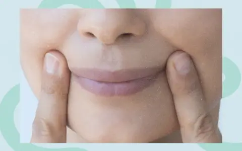 Fingers press into the cheeks, creating dimples. Could this be one of the unexpected side effects of face yoga?