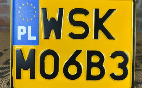 Żółta tablica rejestracyjna z czarnymi znakami "WSK MO6B3" i niebieskim polem "PL" z gwiazdkami UE.