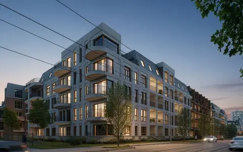 Nowe inwestycje Poznań: nowoczesne apartamentowce z balkonami i mansardowymi dachami, oświetlone wieczornym światłem, przy ulicy z torami tramwajowymi.