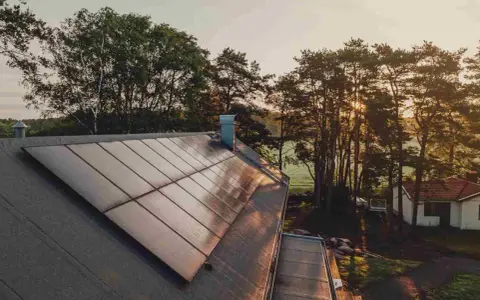 Solpaneler på ett tak i solnedgången, en vacker vy av Svea Solar AB:s arbete.