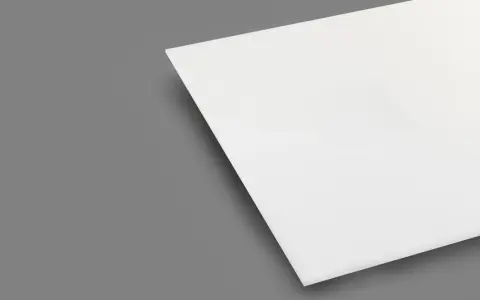 A white sheet of plexiglass is shown on a gray background. This material is known for being heat resistant, making it suitable for various applications.