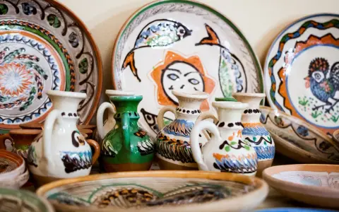 Collection de poteries peintes à la main, dont des cruches et des assiettes décorées, des pièces recherchées de Vallauris.