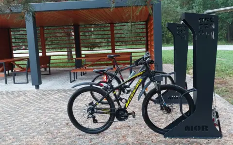 Miejsce obsługi rowerzystów z wiatą i stojakami. Dwa rowery czekają na dalszą podróż.