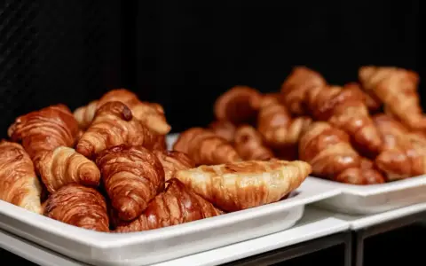 Pyszne rogaliki na śniadanie w hotelu garni. Złociste, chrupiące wypieki kuszą swoim aromatem.
