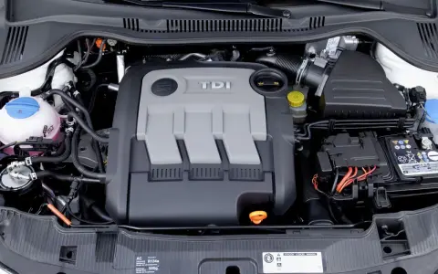 Silnik 1.4 TDI z widocznym osprzętem, akumulatorem i płynem chłodniczym.