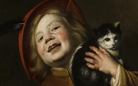 Dziecko w czerwonym kapeluszu z piórkiem, trzymające czarno-białego kota. Obraz Judith Leyster.