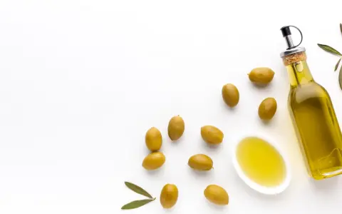 Botella de aceite de oliva virgen extra y aceitunas verdes. El mejor aceite de oliva para tomar crudo, con un sabor fresco y puro.