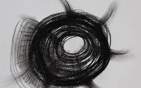 Abstract charcoal mark making examples, featuring a dark, spiraling circle with radiating lines on a white background.