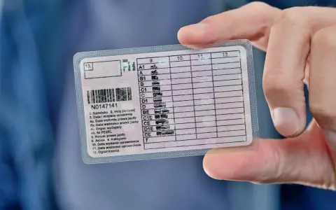 Prawo jazdy z zaznaczoną kategorią CE. Dokument w ręku, widoczne dane kierowcy i kategorie uprawnień.