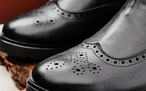 Eleganckie, czarne buty zimowe do garnituru z perforacją. Idealne na chłodne dni, gdy chcesz wyglądać stylowo.