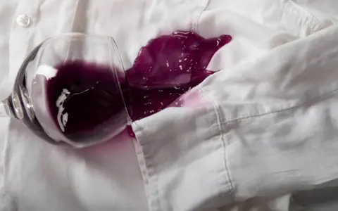 Un bicchiere rovesciato su una camicia bianca ha creato una macchia di vino rosso. Ecco come togliere macchie vino rosso secche.