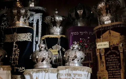 Srebrne korony i ozdobne zwoje Tory, przypominające o królewskiej chwale i mądrości z Psalmu 21.