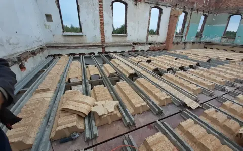 Trwa wymiana stropu w starym domu. Betonowe belki i płyty OSB tworzą nową konstrukcję.