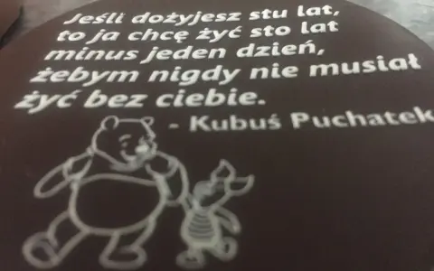 Czekoladowy medalion z cytatem Kubusia Puchatka i rysunkiem Kubusia i Prosiaczka.
