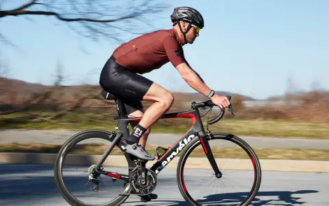 Cyclist in motion, demonstrating optimal road bike seat height for efficient pedaling.