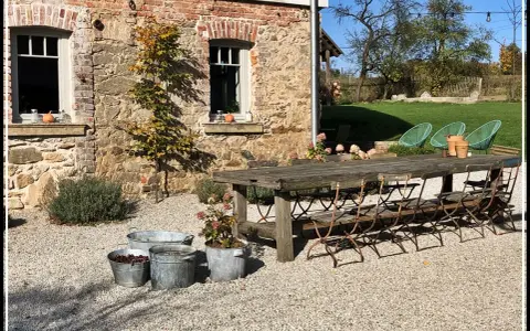 Rusty metal chairs await guests at a rustic table, perfect for enjoying the charm of agroturystyka Dolny Śląsk.
