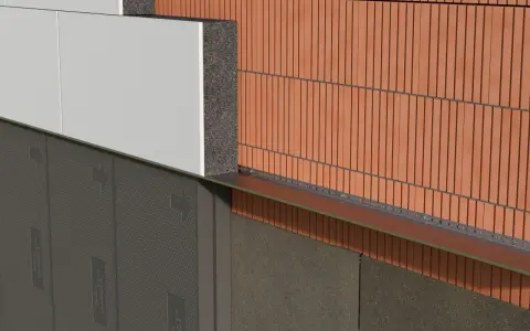 Warstwa styropianu izoluje budynek, tworząc barierę termiczną. Widoczna cegła klinkierowa i płyty elewacyjne.