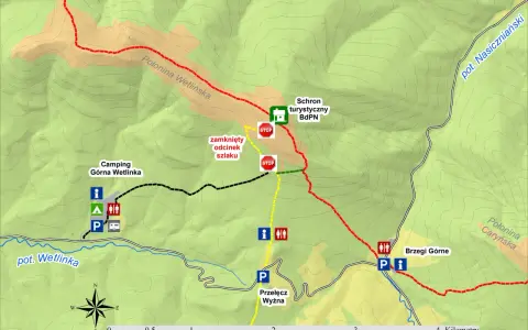 Mapa turystyczna z zaznaczonymi szlakami, schroniskiem, campingiem Górna Wetlinka i połoniną Wetlińską. Widoczny zamknięty odcinek szlaku.