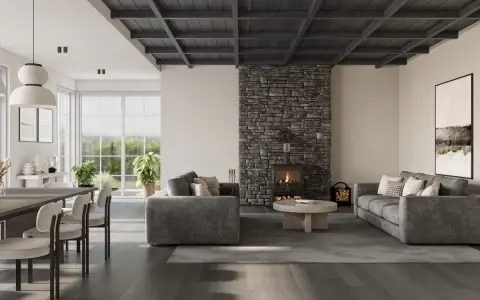 Salón moderno con chimenea de piedra, sofás grises y techos oscuros de madera que crean un ambiente acogedor.