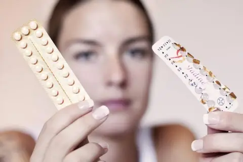 Frau hält zwei Pillenpackungen. Eine ist leer, die andere zeigt noch viele Pillen. Die pille zeitverschiebung ist ein wichtiges Thema.